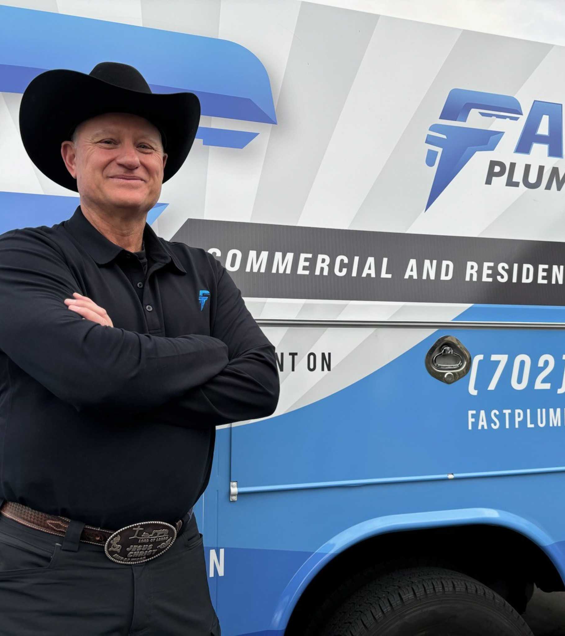 Man in cowboy hat standing in front of Fast Plumbing truck